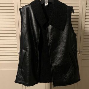 NWT Black Faux leather Sleeveless Women's jacket. Feels and looks like leather